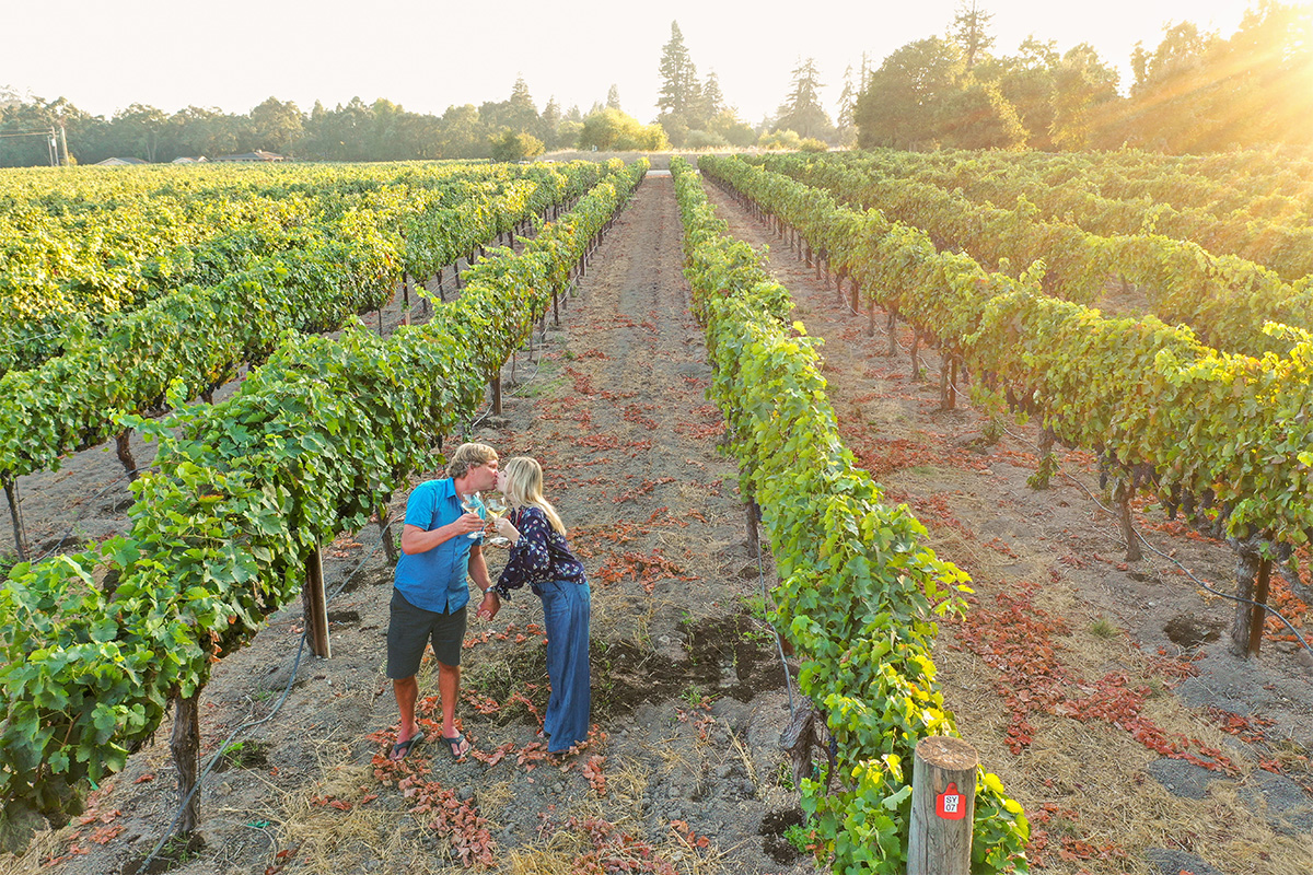Winemaker Rob Lloyd in a vineyard with his partner Bonnie.