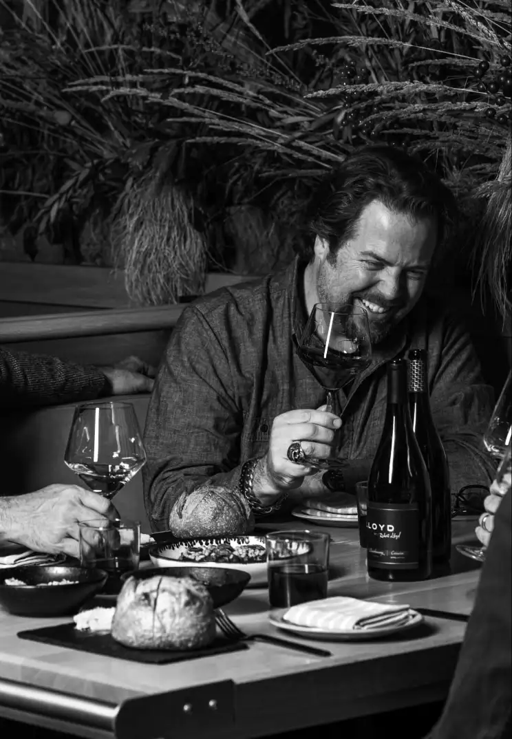 man enjoying dinner and wines with friends 