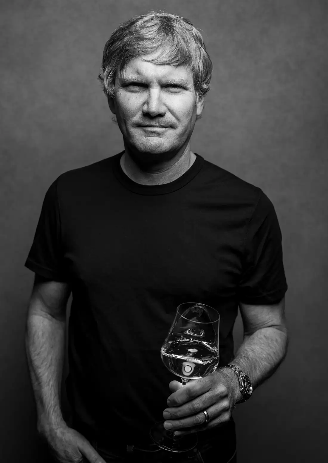 Rob Lloyd holding a glass of wine.
