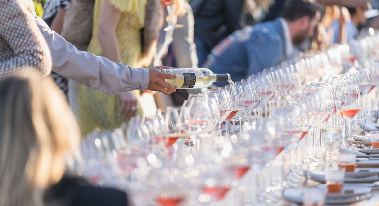 Photo of a server pouring a glass of Sauvignon Blanc to the table.