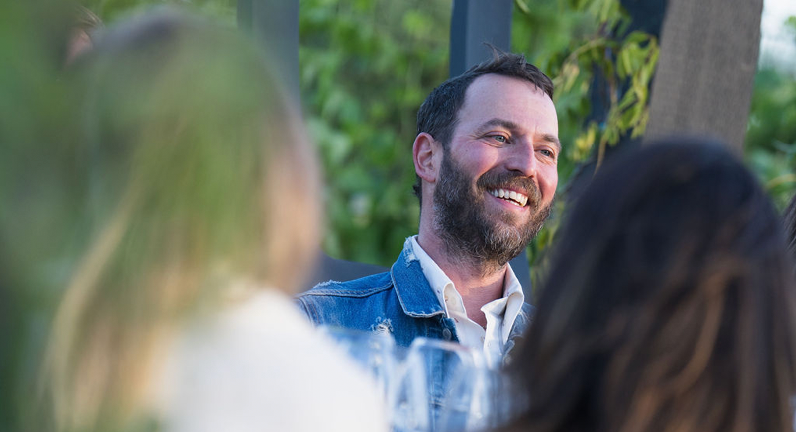 Photo of a guest smiling and enjoying the conversation.