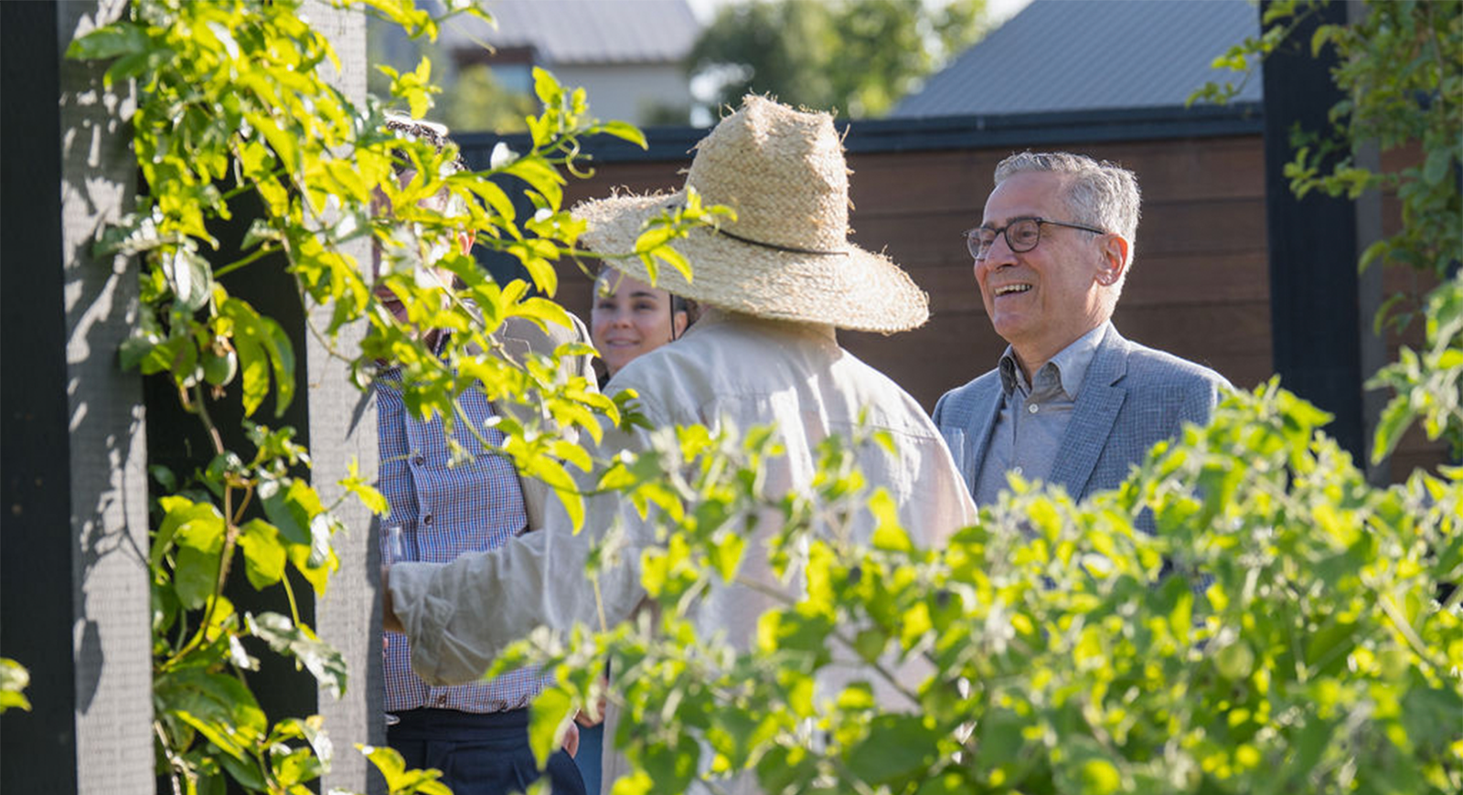Photo of the Grange farmer talking with guests about the farm-to-table experience.