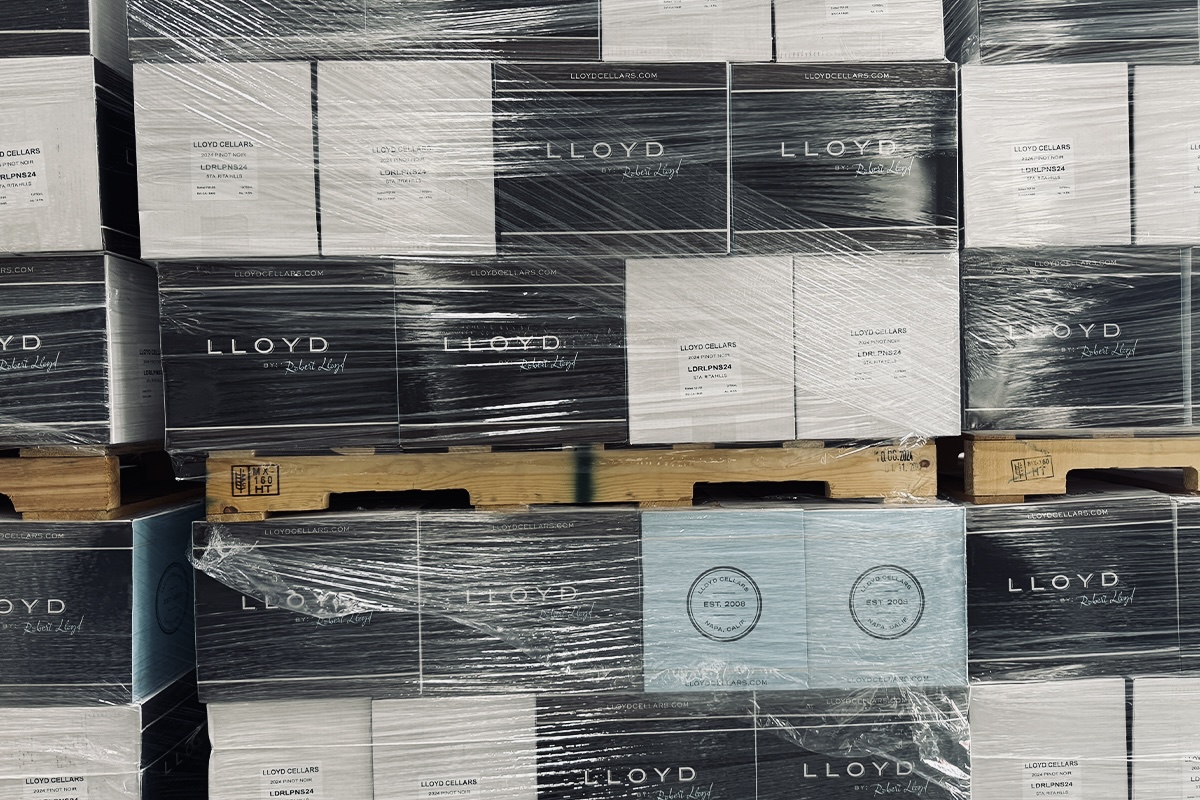Stacked pallets of Lloyd Cellars wine cases wrapped for warehouse distribution