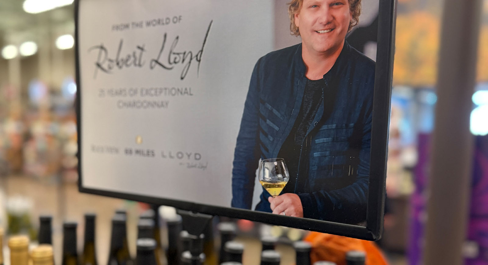 Lloyd Cellars point-of-sale display at Total Wine & More with a portrait of winemaker Rob Lloyd and Lloyd wine bottles displayed below.