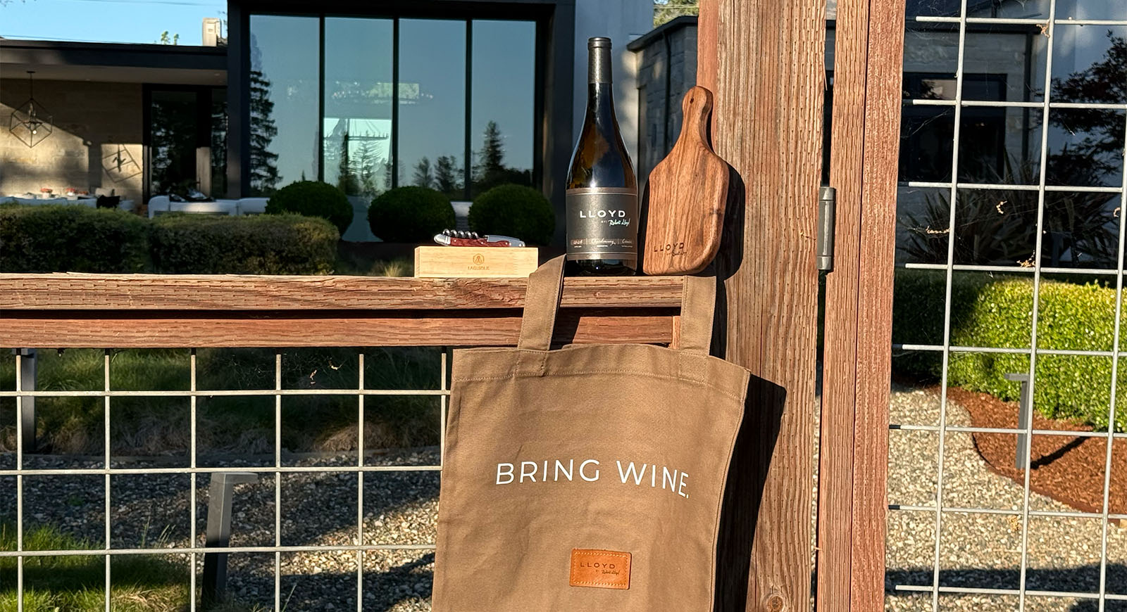 Lloyd Cellars Release No. 01 — The Hosting Set: BRING WINE. canvas tote, walnut serving board, and Laguiole corkscrew